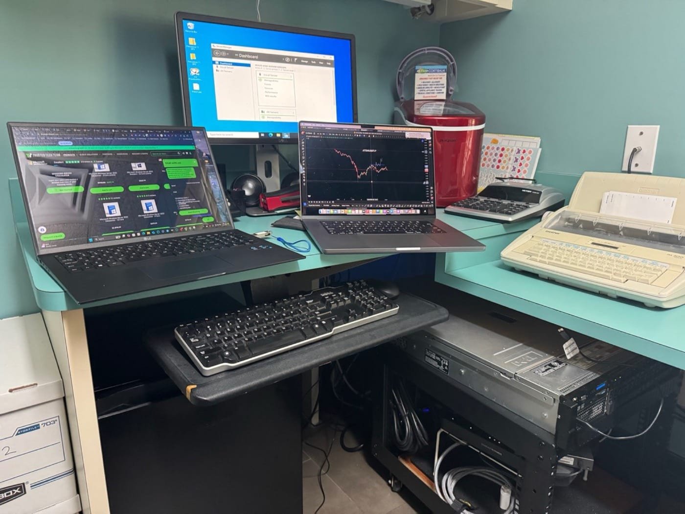 Atascocita IT repair workbench with laptops, monitor, and diagnostic equipment