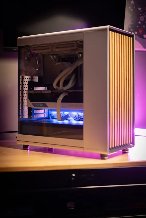 White custom desktop build with a wood-slat front panel and liquid cooling