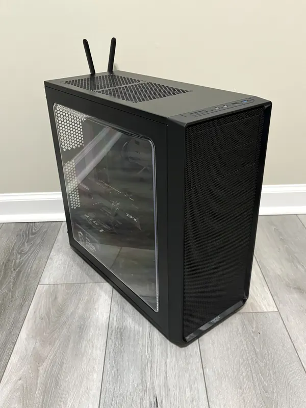 Finished black workstation tower with a side window and Wi-Fi antennas